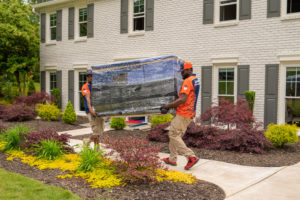 Residential Movers Moving Wrapped TV Into House in Atlanta