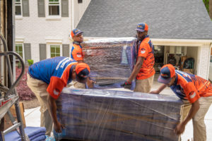 Residential Movers in uniform carrying boxes in and out of the house in Atlanta