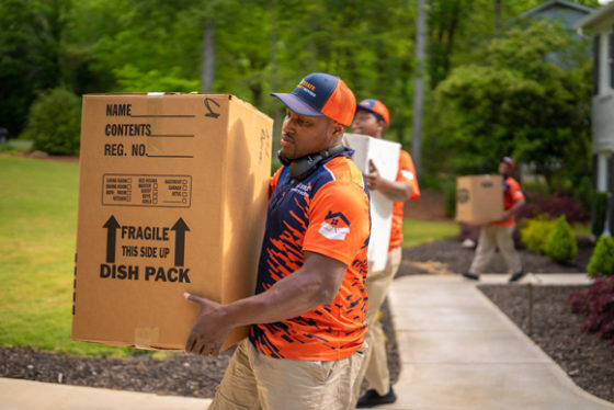 White-glove local movers in Fulton County carrying boxes to a home