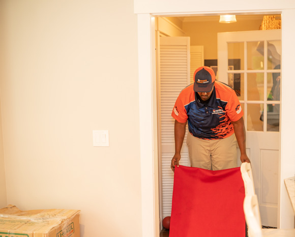 Residential mover putting protective floor mats for a local move