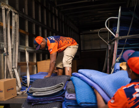 professional movers packing up a moving truck and providing services such as Full-Service Movers for Commercial and Office Moves in Johns Creek, GA