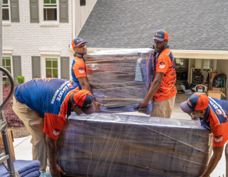 a group of professional movers loading furniture while providing services such as Home Movers, Local Movers, and Long Distance Movers in Acworth, GA