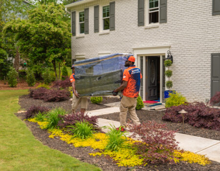 workers holding furniture while providing services such as Full-Service Movers, Interstate Mover, Local Movers, and Moving Company Serving McDonough, GA