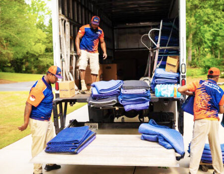 a group of professional movers loading a truck while providing services such as White Glove Movers For Corporate and Commercial Moves in Acworth, GA